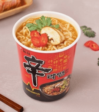 Shin Ramyun, Korea’s classic spicy instant noodle, in a red package with bold black calligraphy.