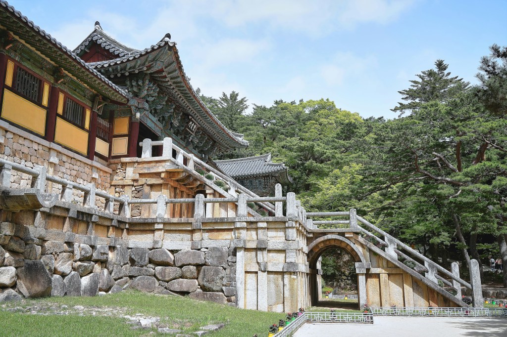 Bulguksa Temple in Gyeongju, a UNESCO World Heritage Site, featuring ancient stone pagodas and temple buildings surrounded by nature.